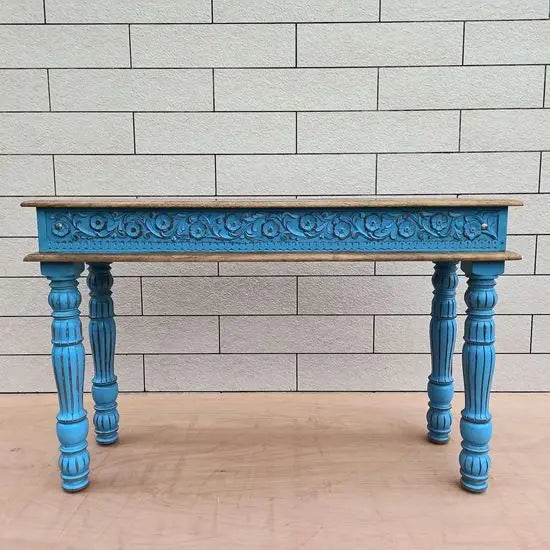 A rustic blue console table with turned legs made of mango wood with a natural top.