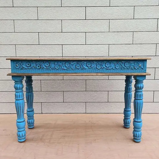 A rustic blue console table with turned legs made of mango wood with a natural top.