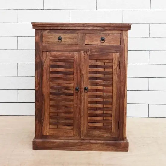 A wooden shoe rack with multiple shelves and closed doors, finished in natural wood  color, with a metal handle.