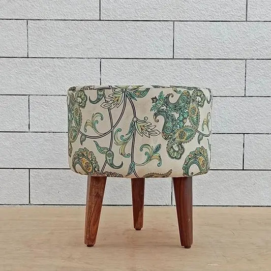 A round Cream Pouf with floral fabric design on top, supported by three wooden legs.