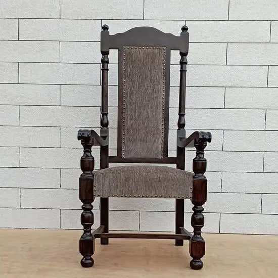A wooden high back chair with armrests, upholstered in grey fabric, made of Sheesham wood.