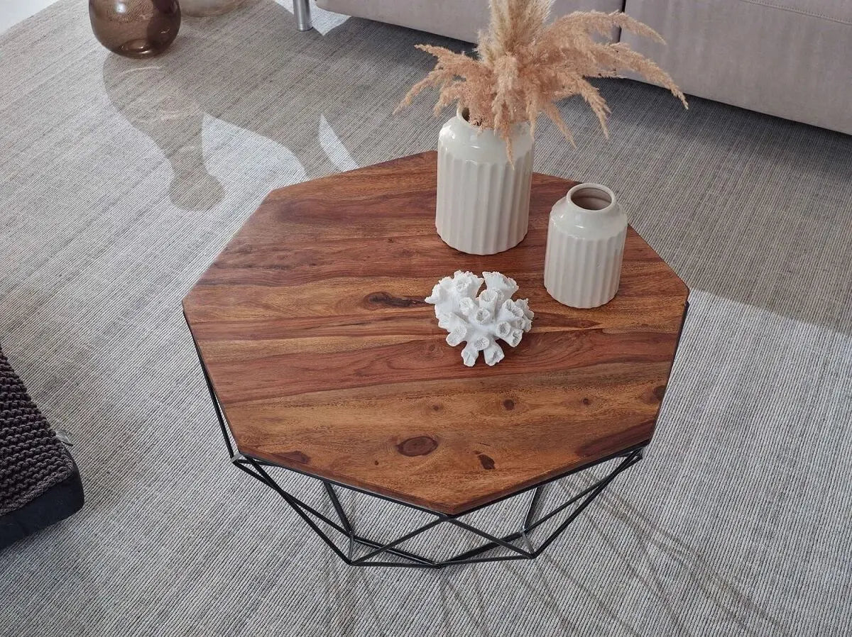 Hexagonal wooden Kerry coffee table with geometric black metal base.