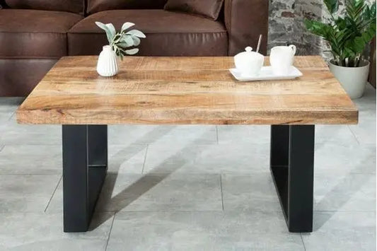 A medium-sized coffee table with a distressed finish mango wood top and black metal legs.