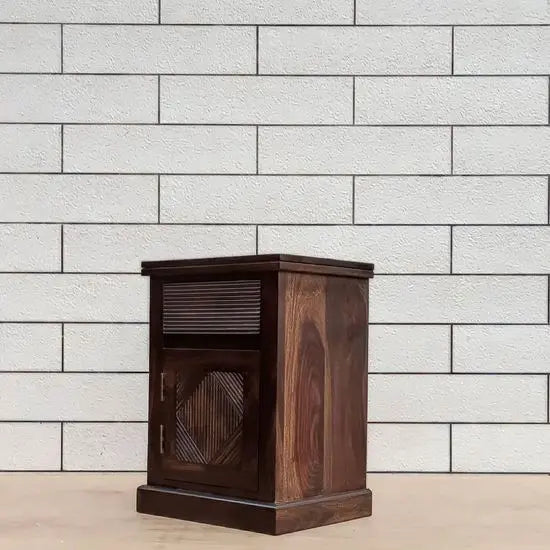 A wooden bedside table with a group design on the front made in Solid sheesham wood.