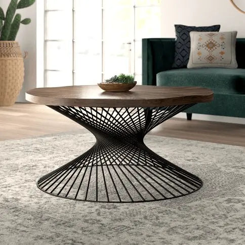 A round Sprial coffee table with a mango wood top and a black metal spiral base.