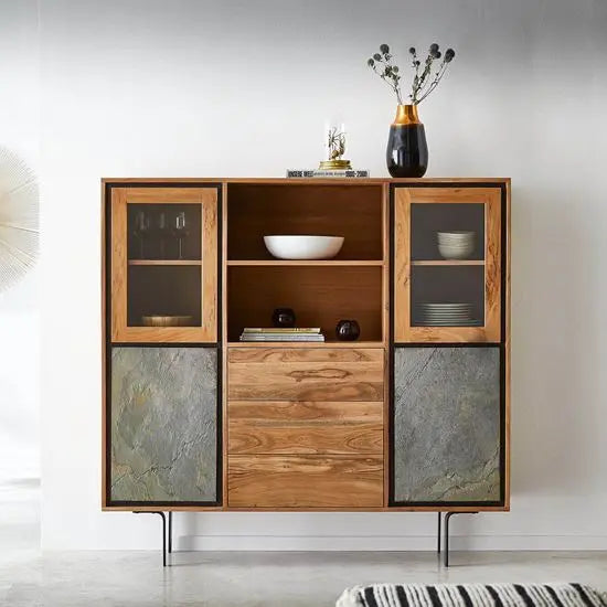 A Jarrah Crockery Cabinet with two glass doors, two closed doors, and three push-to-open drawers, constructed from acacia wood with metal legs, featuring dishes and decor items inside.