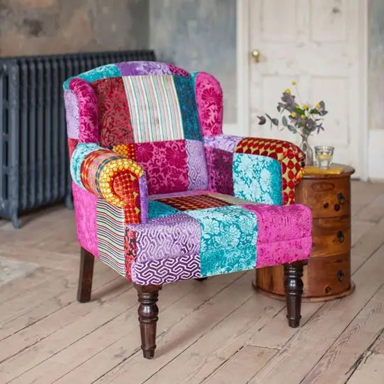 A multicolored patchwork velvet upholstered Maharaja wing chair.