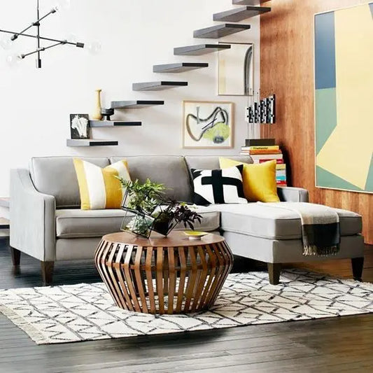 An L-shaped sofa in a living room setting with gray upholstery.
