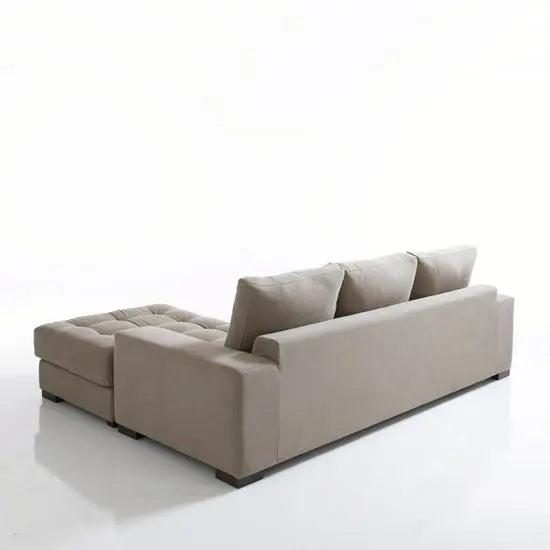 Four seater L-shaped sofa in a living room setting with a modern design, light gray fabric.