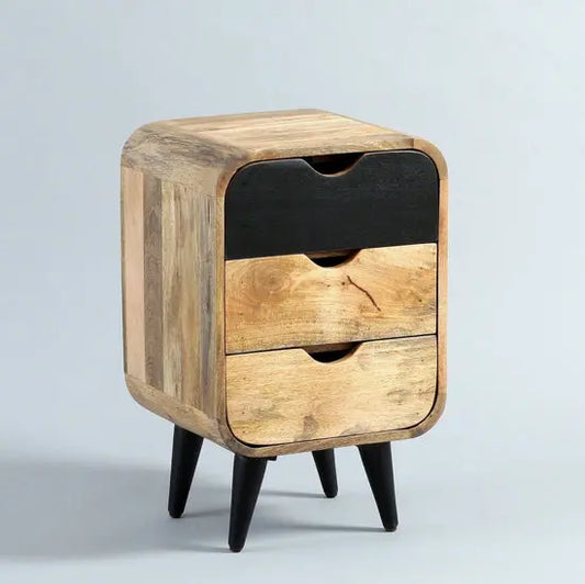 A black Braithwaite Bedside Table made of mango wood with three drawers and knockdown legs.