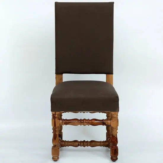 A brown upholstered padded chair with a wooden frame and a tufted backrest.