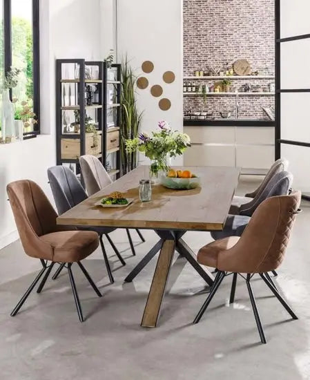 A modern farmhouse-style dining table made of wood with a metal base.