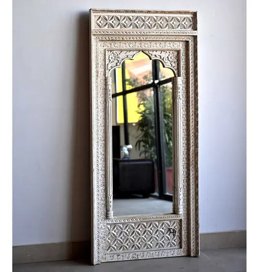 A white hand-carved wooden mirror frame with intricate designs, displayed against a plain background.
