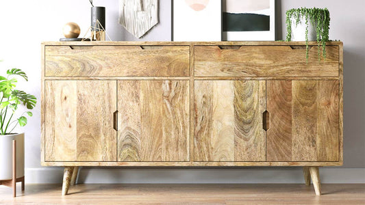 A mid-century modern wooden sideboard cabinet with a natural light wood finish and tapered legs.