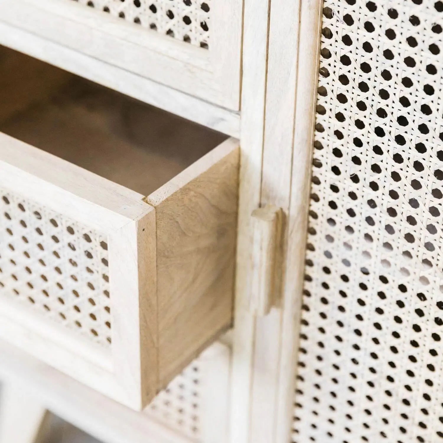 Wooden cabinet with perforated design on doors and sides.