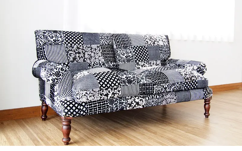 Two seater Pattern Black Sparrow Sofa with four carving legs.