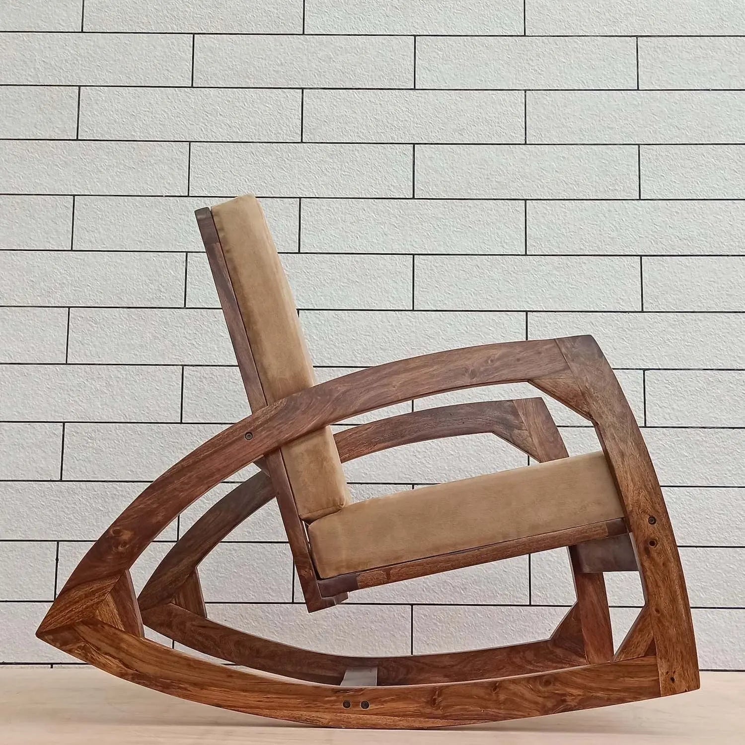 Sheesham wood designer rocking chair with beige cushion.