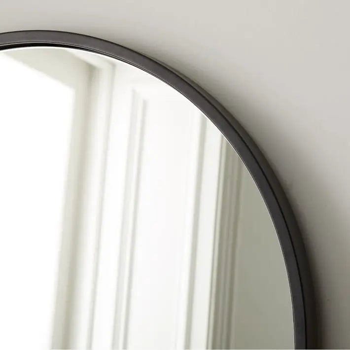 Top round mirror with a black metal frame.