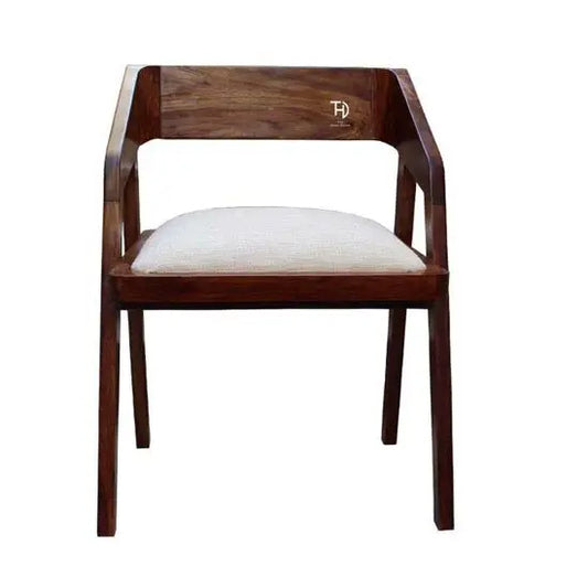 A brown Loria chair with an upholstered seat, made from solid Sheesham wood.