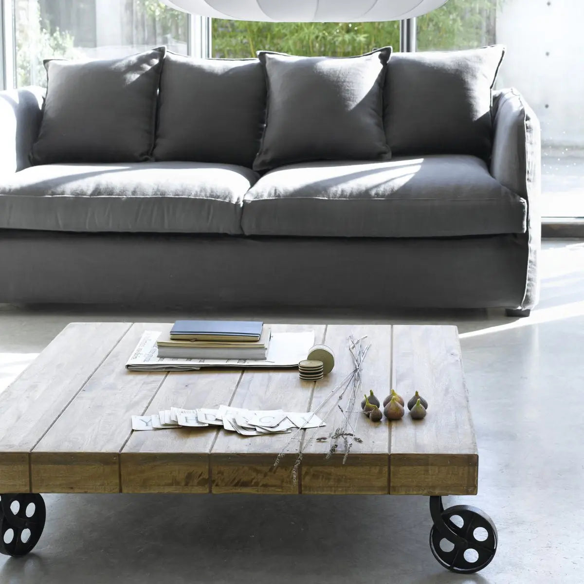 Low height Devi square coffee table with wheels made in Solid mango wood and metal frame. 