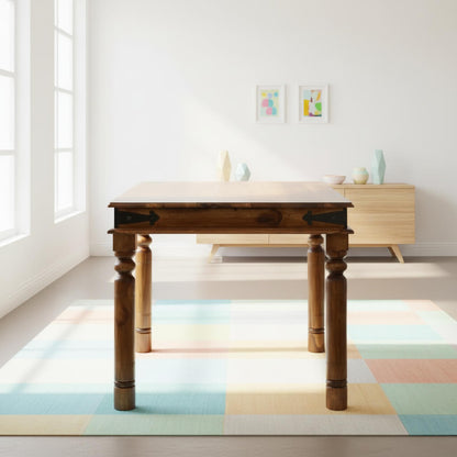 A vintage style dining table made of Sheesham wood with a rectangular top and carved legs, designed to seat five people.