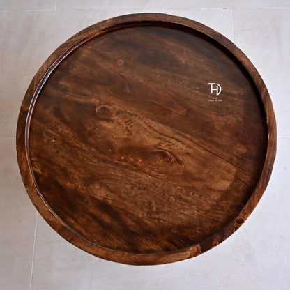 Round wooden trendy ringbud coffee table with intricate carvings and curved legs. 