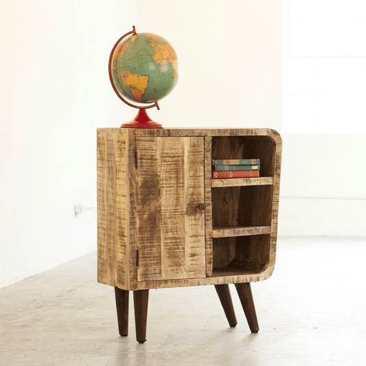 A rustic cabinet made of mango wood with a distressed finish, featuring a single door and three open shelves, placed on pointed-turned legs.