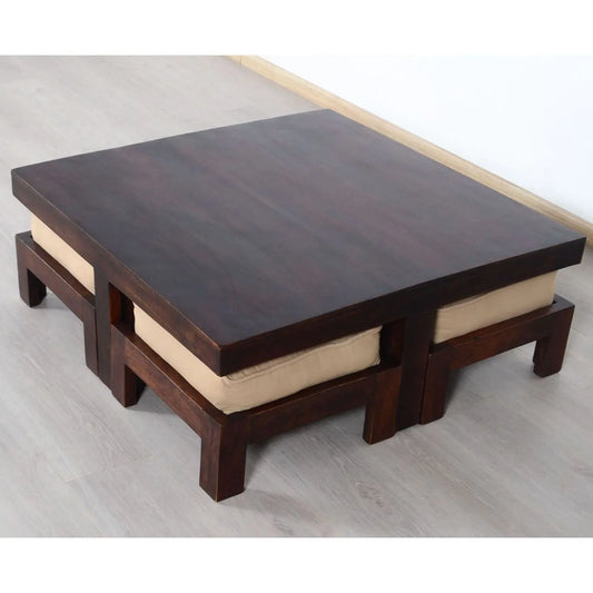 A low-profile square coffee table with dark wood finish and beige cushioned edges.