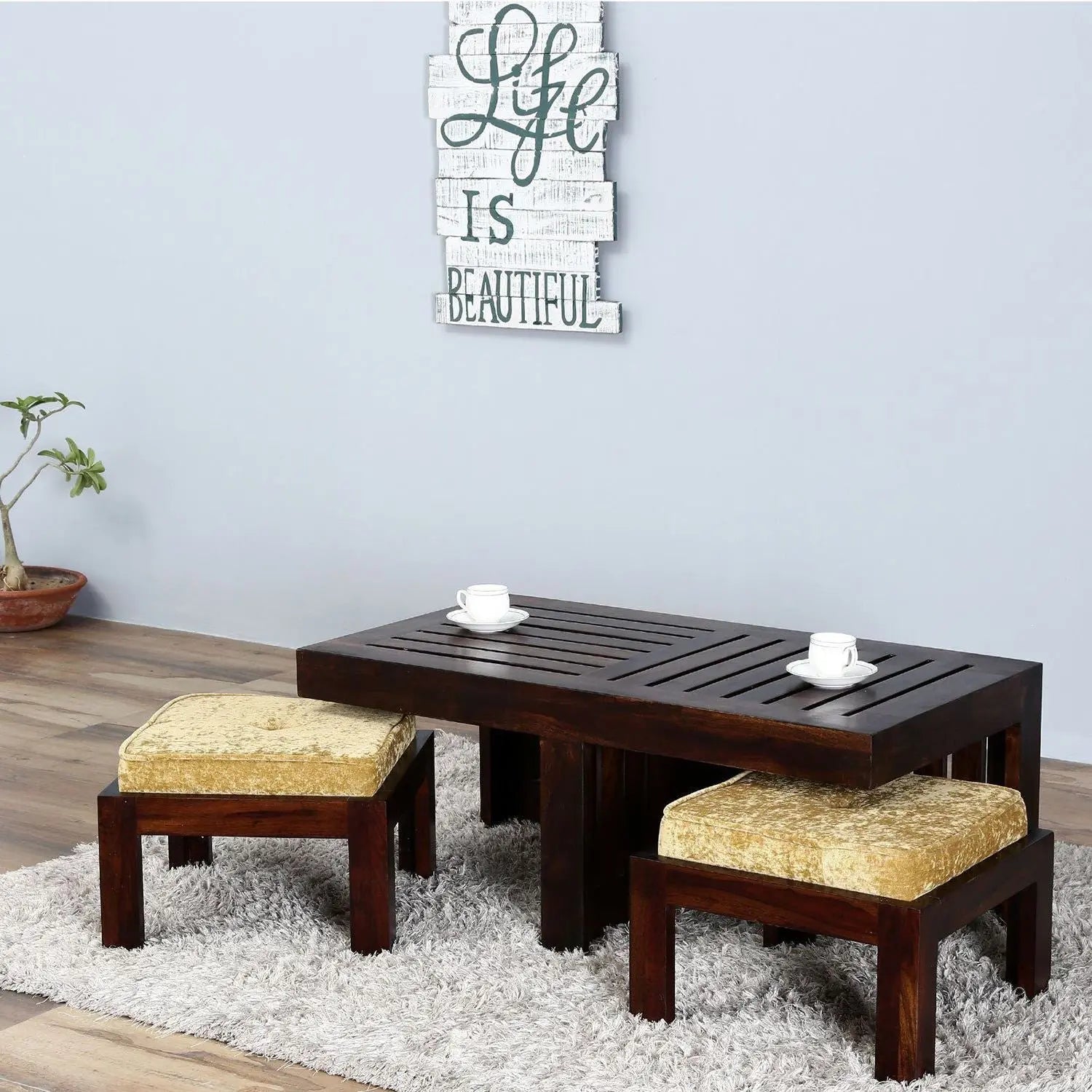 Solid wood Rectangle shilbyra coffee table with two cushioned stools. 