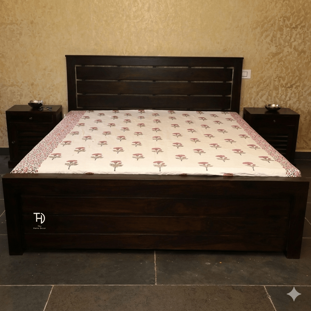 Handcrafted wooden bed with a floral pattern on the bedding, a solid brown finish on the legs, and front drawer storage.