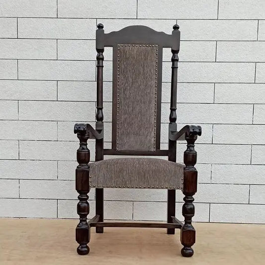 A wooden high back chair with armrests, upholstered in grey fabric, made of Sheesham wood.