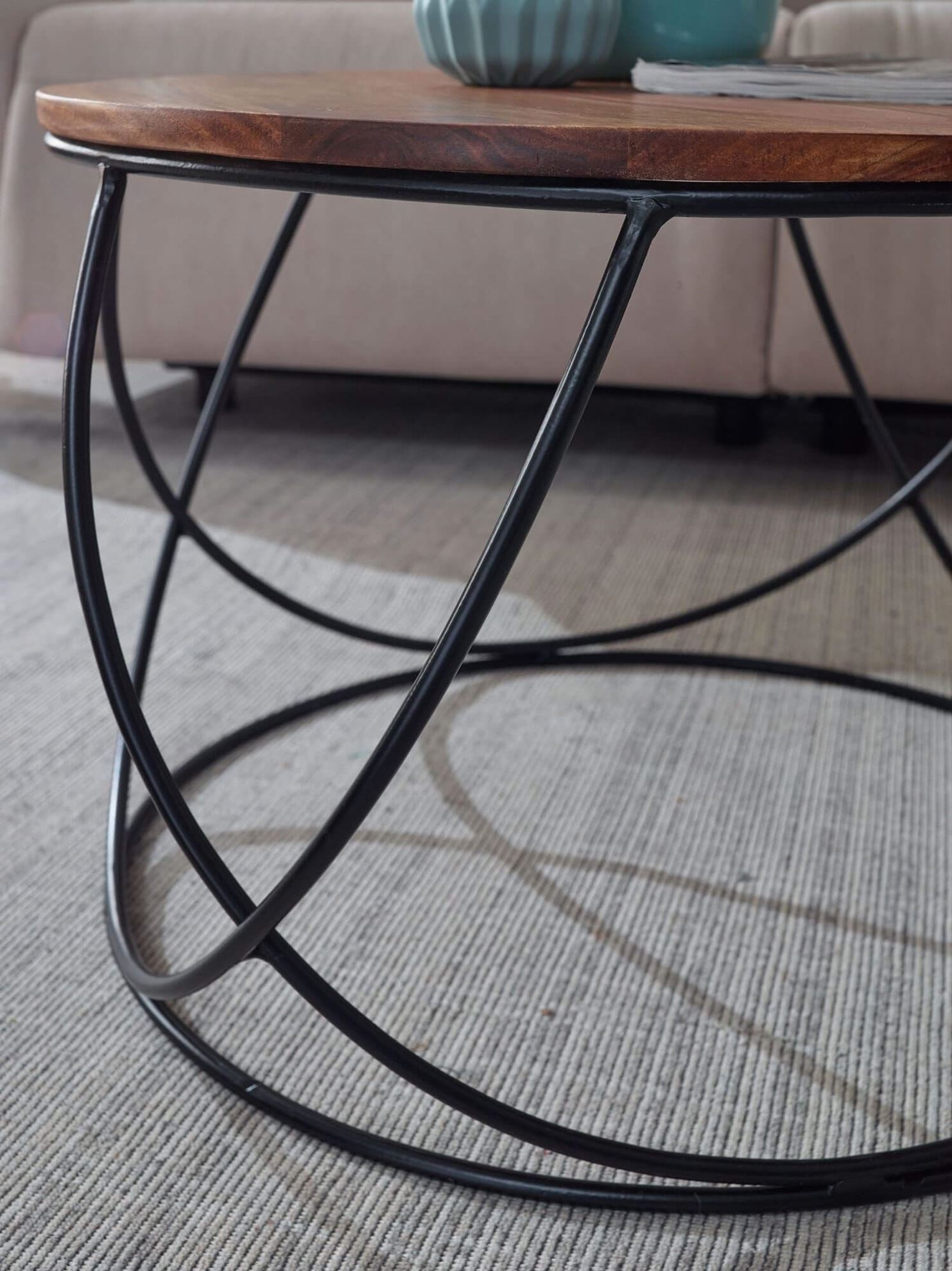 Solid Sheesham wood Round shape Ring coffee table with a black metal base. 