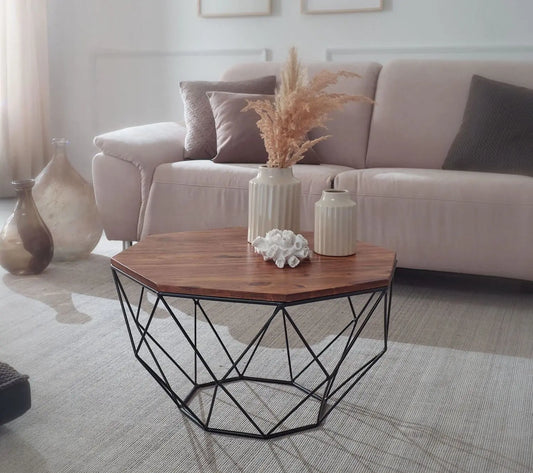 A Hexagonal brown coffee table with a geometric black metal base.