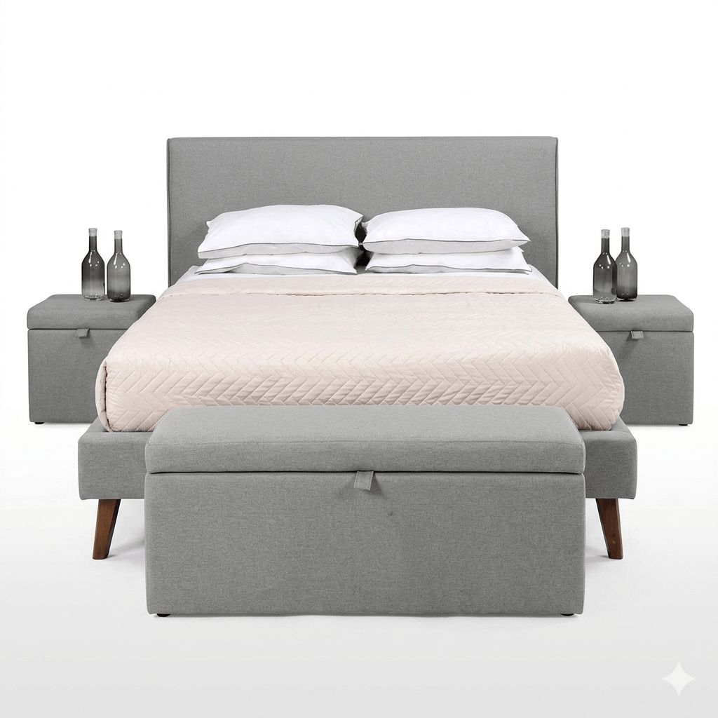 A gray upholstered storage bench at the foot of a bed, with a closed lid and a cushion on top for seating.