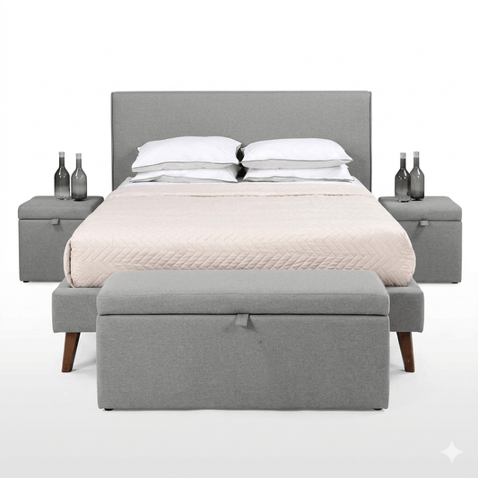 A gray upholstered storage bench at the foot of a bed, with a closed lid and a cushion on top for seating.