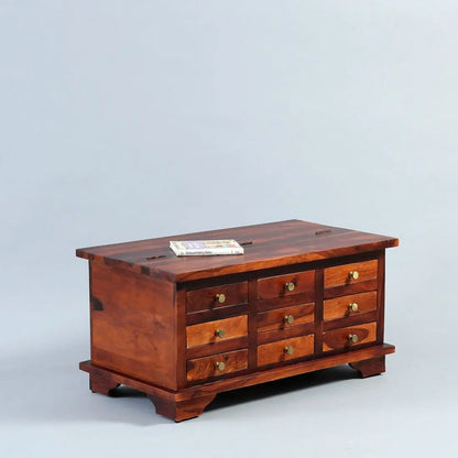 A rectangular wooden coffee table with multiple drawers and metal Knobs.