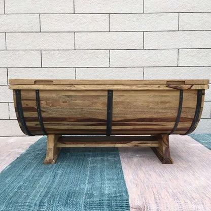Solid wood barrel shaped coffee table with metal strips on the sides.