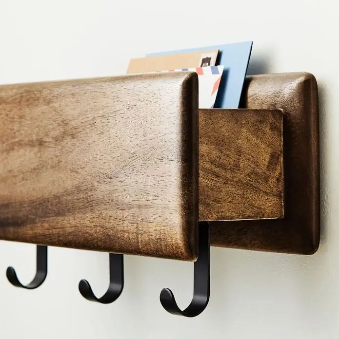 Wooden wall-mounted mail organizer with three hooks holding Modern wall rack. 