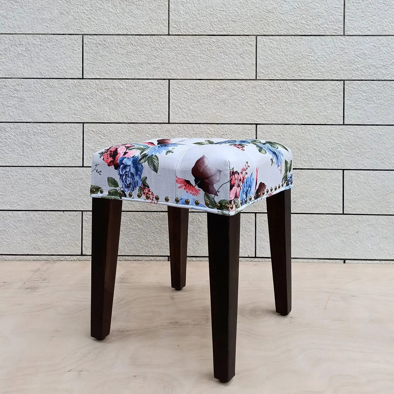 Solid wood Stool with floral patterned seat.