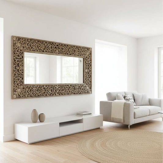 A hand-carved wooden mirror frame with floral patterns,