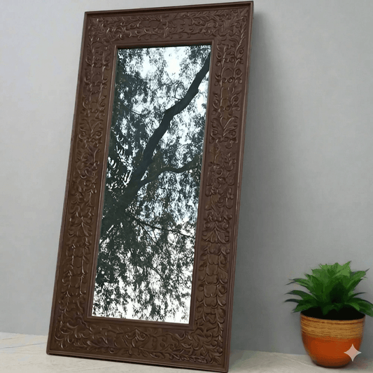 A rustic Aklavya mirror frame made of Sheesham wood with intricate hand-carved details.