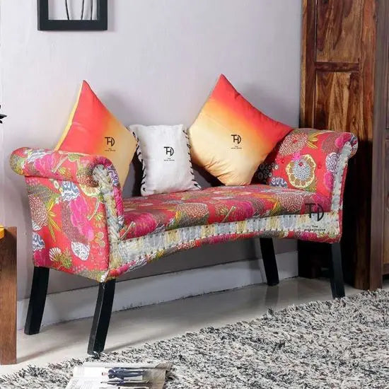 Two seater curve shape Bench with multicolor fabric upholstery and dark wood legs.