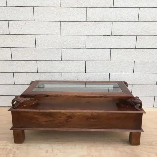 wooden rectangular brown Three drawer and carved elephant details on the sides Asgil coffee table.
