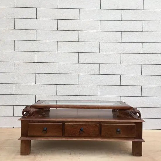 Solid wood rectangular brown Three drawer and carved elephant details on the sides Asgil coffee table.