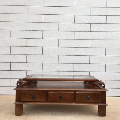 Solid wood rectangular brown Three drawer and carved elephant details on the sides Asgil coffee table.