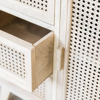 Wooden cabinet with perforated design on doors and sides.