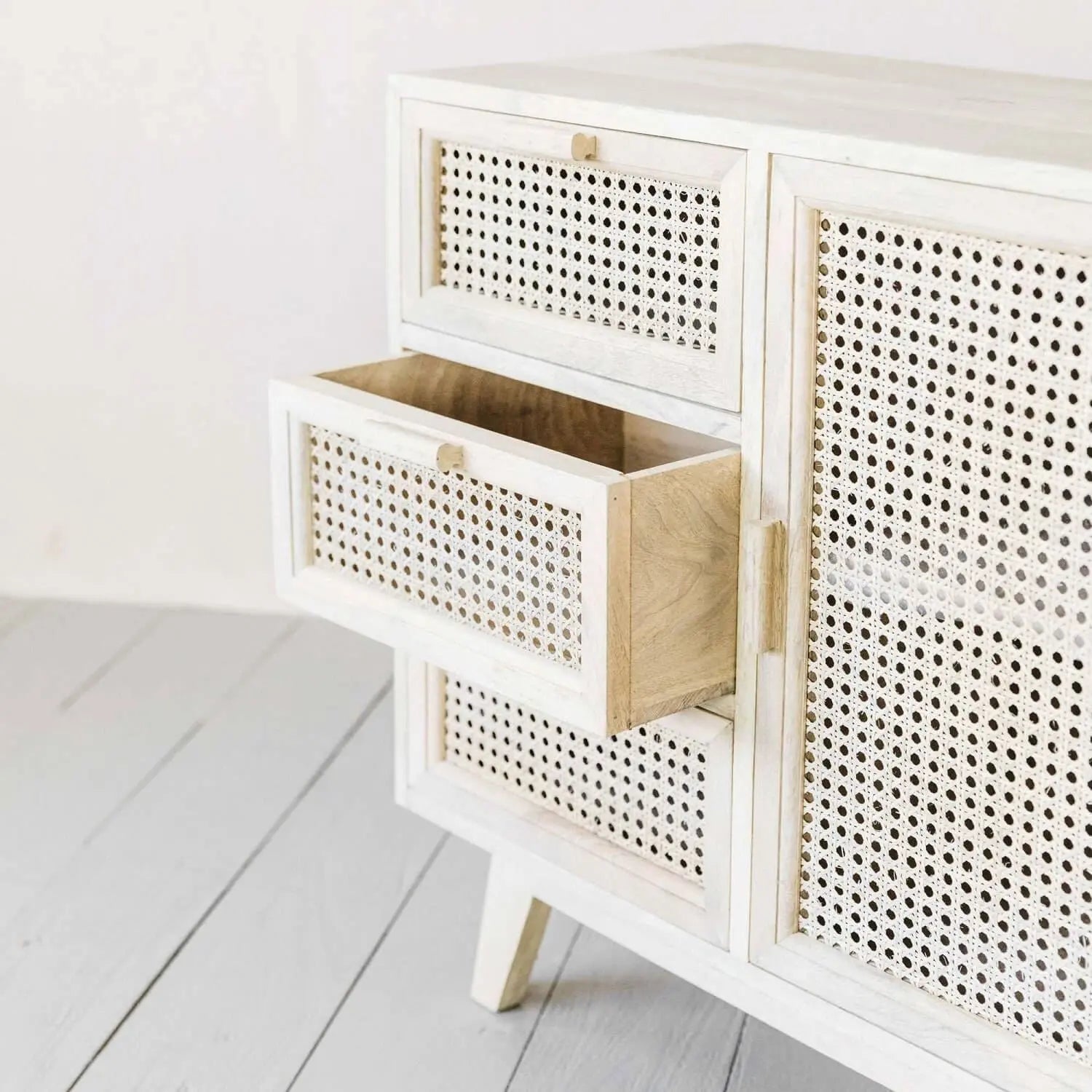 White solid wood cabinet with rattan door and drawers. 