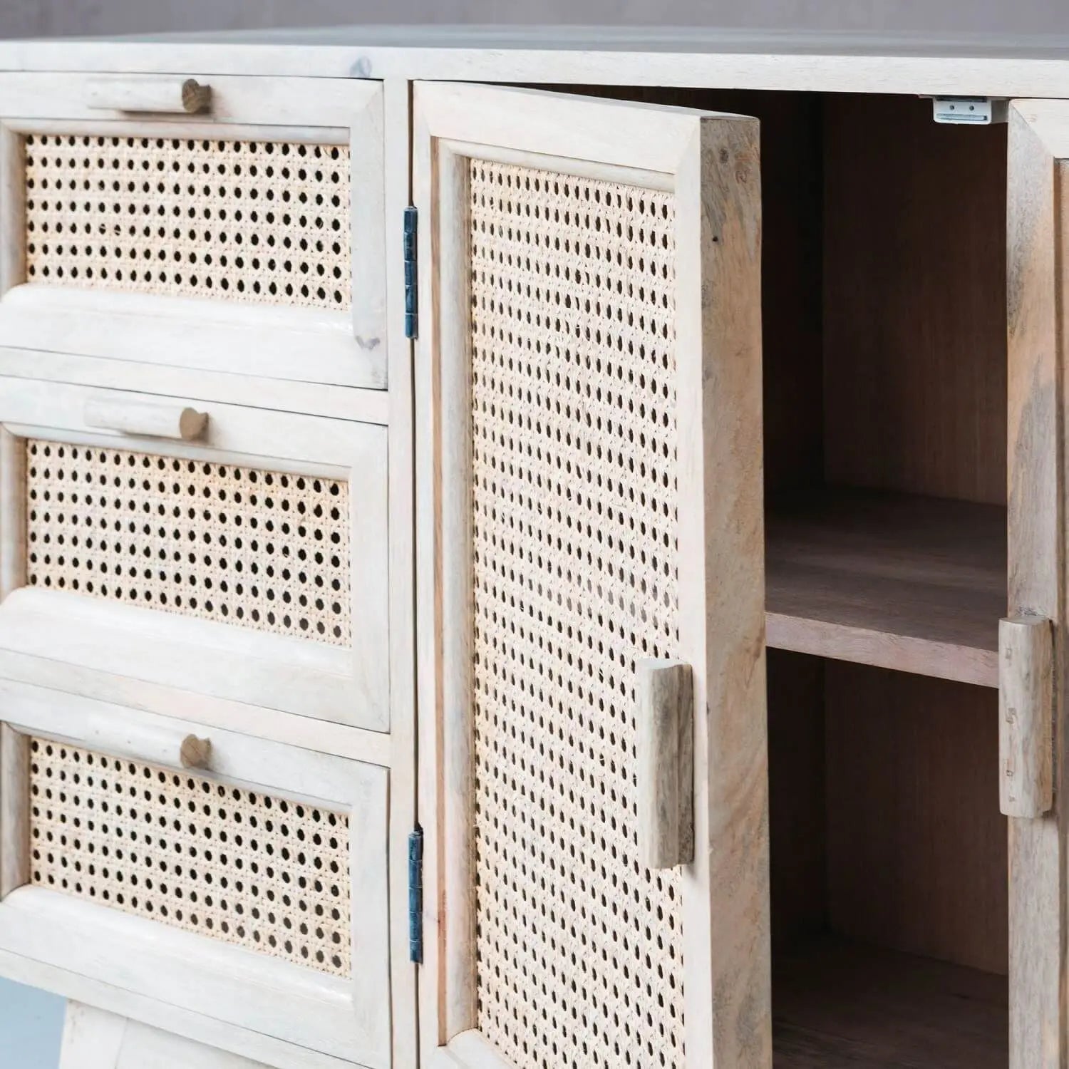 Wooden cabinet with rattan-style doors and drawers