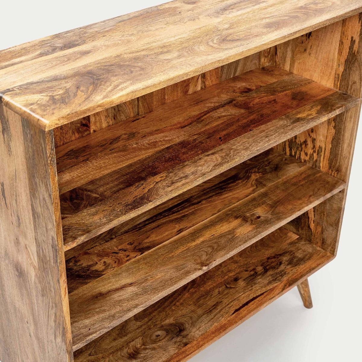 A rustic wooden bookshelf with three shelves, made from natural wood with prominent grain patterns and knots.
