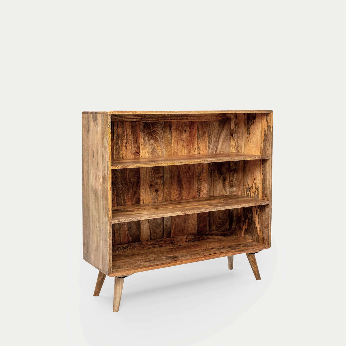 A mid-century modern solid wood bookcase with three shelves and tapered legs.